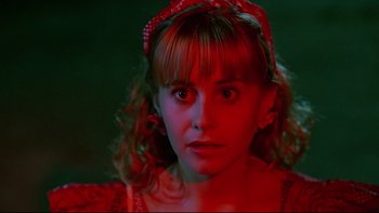 Movie still from “Psycho IV: The Beginning” (1990), directed by Mick Garris – A woman with a red headband is looking at the camera; Close Up shot, Low angle