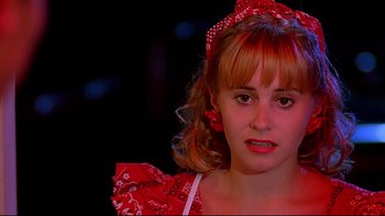 Movie still from “Psycho IV: The Beginning” (1990), directed by Mick Garris – A young girl in a red dress and a red bandanna on her head; Close Up shot, Low angle