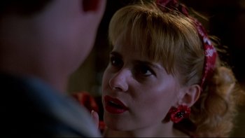 Movie still from “Psycho IV: The Beginning” (1990), directed by Mick Garris – A person wearing a red and white headband; Close Up shot, Over the shoulder angle