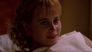 Movie still from “Psycho IV: The Beginning” (1990), directed by Mick Garris – A young woman with blonde hair wearing a white shirt; Close Up shot, Low angle