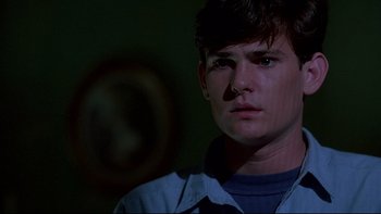 Movie still from “Psycho IV: The Beginning” (1990), directed by Mick Garris – A man with a nose ring looking at the camera; Close Up shot, Over the shoulder angle