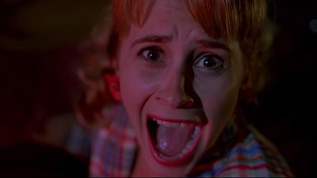 Movie still from “Psycho IV: The Beginning” (1990), directed by Mick Garris – A woman with a goofy look on her face; Close Up shot, High angle