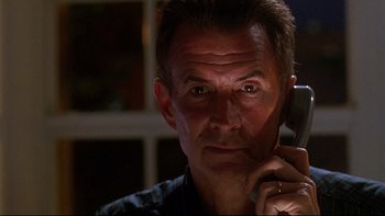 Movie still from “Psycho IV: The Beginning” (1990), directed by Mick Garris – A person talking on a cell phone; Close Up shot, Low angle