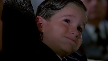 Movie still from “Psycho IV: The Beginning” (1990), directed by Mick Garris – A young boy wearing a suit and tie; Close Up shot, Low angle