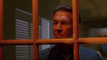Movie still from “Psycho IV: The Beginning” (1990), directed by Mick Garris – A person looking through a window; Close Up shot, Low angle