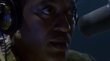 Movie still from “Psycho IV: The Beginning” (1990), directed by Mick Garris – A person with a microphone; Close Up shot, Low angle