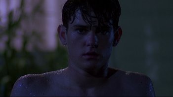 Movie still from “Psycho IV: The Beginning” (1990), directed by Mick Garris – A young man with wet hair and no shirt in the dark; Close Up shot, Low angle