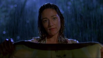 Movie still from “Psycho IV: The Beginning” (1990), directed by Mick Garris – A person in the rain near a window; Medium shot, Low angle