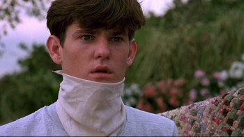 Movie still from “Psycho IV: The Beginning” (1990), directed by Mick Garris – A young man wearing a bandage around his neck; Close Up shot, Low angle