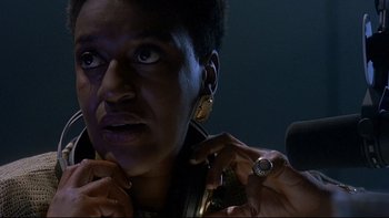 Movie still from “Psycho IV: The Beginning” (1990), directed by Mick Garris – A person holding a microphone; Close Up shot, Low angle