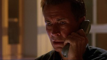 Movie still from “Psycho IV: The Beginning” (1990), directed by Mick Garris – A person talking on a cell phone; Close Up shot, Low angle