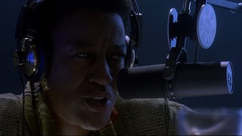 Movie still from “Psycho IV: The Beginning” (1990), directed by Mick Garris – A person with a microphone in front of a microphone; Close Up shot, Low angle