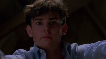Movie still from “Psycho IV: The Beginning” (1990), directed by Mick Garris – A young man is looking into the camera; Close Up shot, Low angle
