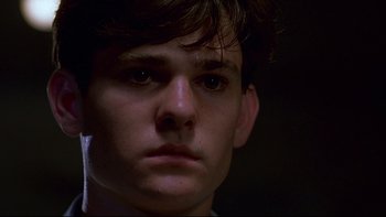 Movie still from “Psycho IV: The Beginning” (1990), directed by Mick Garris – A young man's face in the dark; Close Up shot, Low angle