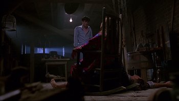 Movie still from “Psycho IV: The Beginning” (1990), directed by Mick Garris – Two people are sitting in a rocking chair; Wide shot, High angle