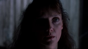 Movie still from “Psycho IV: The Beginning” (1990), directed by Mick Garris – A person's face in the dark; Close Up shot, Low angle