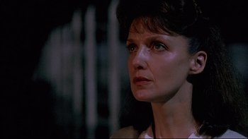 Movie still from “Psycho IV: The Beginning” (1990), directed by Mick Garris – A person looking at the camera; Close Up shot, Low angle