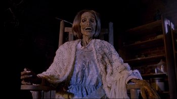 Movie still from “Psycho IV: The Beginning” (1990), directed by Mick Garris – An old woman is sitting in a chair; Medium shot, High angle