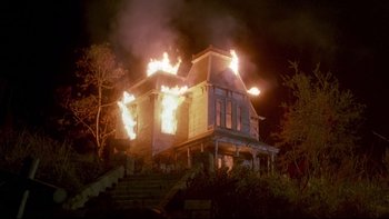 Movie still from “Psycho IV: The Beginning” (1990), directed by Mick Garris – A house that is on fire at night time; Extreme Wide shot, Low angle