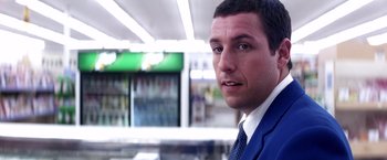 Movie still from “Punch-Drunk Love” (2002), directed by Paul Thomas Anderson – A person wearing a suit and tie; Close Up shot, Over the shoulder angle
