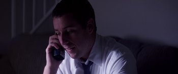 Movie still from “Punch-Drunk Love” (2002), directed by Paul Thomas Anderson – A person talking on a cell phone; Close Up shot, High angle