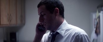 Movie still from “Punch-Drunk Love” (2002), directed by Paul Thomas Anderson – A person talking on a cell phone; Close Up shot, Low angle