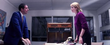 Movie still from “Punch-Drunk Love” (2002), directed by Paul Thomas Anderson – A woman standing in front of an old piano; Medium shot, Low angle
