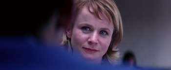 Movie still from “Punch-Drunk Love” (2002), directed by Paul Thomas Anderson – A woman's face with blue eyes; Close Up shot, Over the shoulder angle