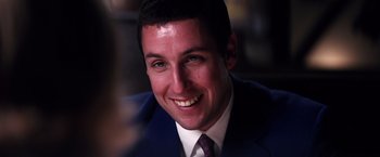 Movie still from “Punch-Drunk Love” (2002), directed by Paul Thomas Anderson – A person wearing a suit and tie; Close Up shot, Over the shoulder angle