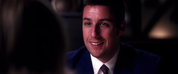 Movie still from “Punch-Drunk Love” (2002), directed by Paul Thomas Anderson – A person wearing a suit and tie; Close Up shot, Over the shoulder angle