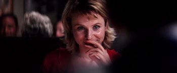 Movie still from “Punch-Drunk Love” (2002), directed by Paul Thomas Anderson – A person with her hand on her chin; Close Up shot, Over the shoulder angle