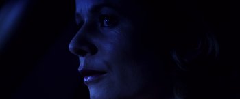 Movie still from “Punch-Drunk Love” (2002), directed by Paul Thomas Anderson – A woman's face in the dark; Extreme Close Up shot, Low angle
