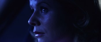 Movie still from “Punch-Drunk Love” (2002), directed by Paul Thomas Anderson – A woman's face in the dark; Extreme Close Up shot, Low angle