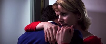 Movie still from “Punch-Drunk Love” (2002), directed by Paul Thomas Anderson – A woman is hugging a man in a red and blue shirt; Close Up shot, Low angle