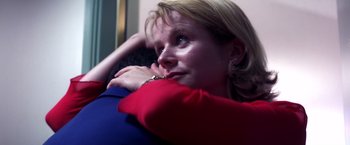 Movie still from “Punch-Drunk Love” (2002), directed by Paul Thomas Anderson – A person sitting on a couch; Close Up shot, Low angle