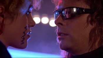 Movie still from “Purple Rain” (1984), directed by Albert Magnoli – A man and a woman face to face in front of lights; Close Up shot, Over the shoulder angle