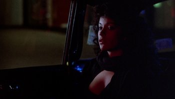 Movie still from “Purple Rain” (1984), directed by Albert Magnoli – A woman sitting in the driver's seat of a car at night; Close Up shot, Low angle
