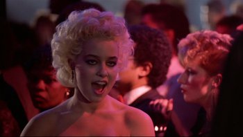 Movie still from “Purple Rain” (1984), directed by Albert Magnoli – A woman with curly hair and a bare face; Close Up shot, Over the shoulder angle