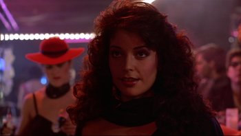 Movie still from “Purple Rain” (1984), directed by Albert Magnoli – A woman with long red curly hair wearing a red hat; Close Up shot, Over the shoulder angle