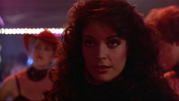 Movie still from “Purple Rain” (1984), directed by Albert Magnoli – A person with long curly hair; Close Up shot, Over the shoulder angle