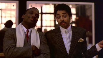 Movie still from “Purple Rain” (1984), directed by Albert Magnoli – A couple of men standing next to each other; Medium shot, Low angle