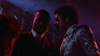 Movie still from “Purple Rain” (1984), directed by Albert Magnoli – A couple of men standing next to each other; Medium shot, Low angle