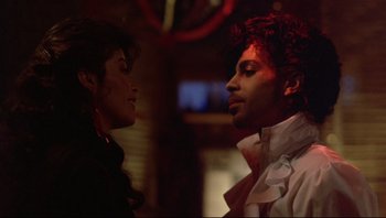 Movie still from “Purple Rain” (1984), directed by Albert Magnoli – A man and a woman standing next to each other; Close Up shot, Low angle