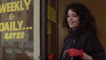 Movie still from “Purple Rain” (1984), directed by Albert Magnoli – A woman in red gloves standing in front of a store window; Close Up shot, Low angle