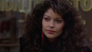 Movie still from “Purple Rain” (1984), directed by Albert Magnoli – A person with long black hair; Close Up shot, Over the shoulder angle