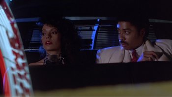 Movie still from “Purple Rain” (1984), directed by Albert Magnoli – A man and a woman sitting in the back of a car; Close Up shot, Low angle