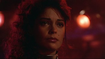 Movie still from “Purple Rain” (1984), directed by Albert Magnoli – A person wearing a red wig; Close Up shot, Over the shoulder angle
