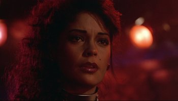 Movie still from “Purple Rain” (1984), directed by Albert Magnoli – A person wearing a necklace; Close Up shot, Over the shoulder angle