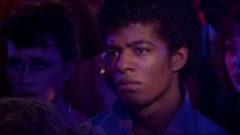 Movie still from “Purple Rain” (1984), directed by Albert Magnoli – A young man is looking into the distance; Close Up shot, Low angle