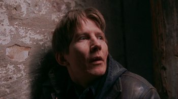 Movie still from “Pusher” (1996), directed by Nicolas Winding Refn – A man in a leather jacket looking up at the sky; Close Up shot, High angle